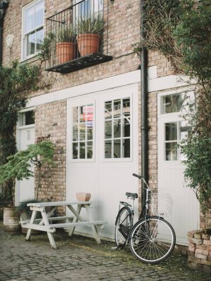 black-bicycle-parked-beside-white-wooden-chair-3639542